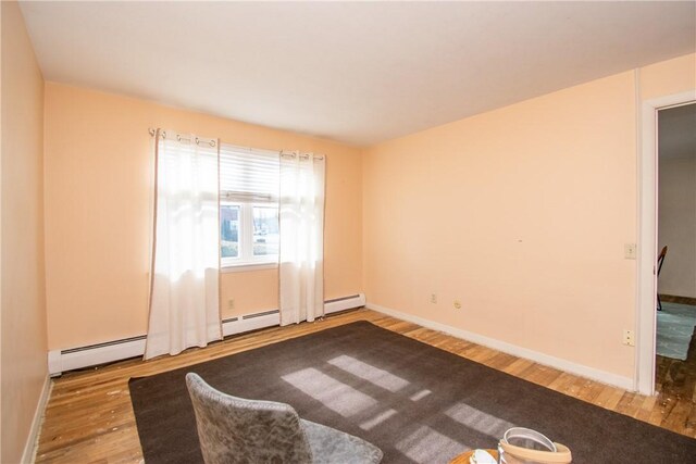 70 Carroll Ave Unit 510, Newport, RI 02840 - unfurnished room with wood finished floors, baseboards, and a baseboard heating unit