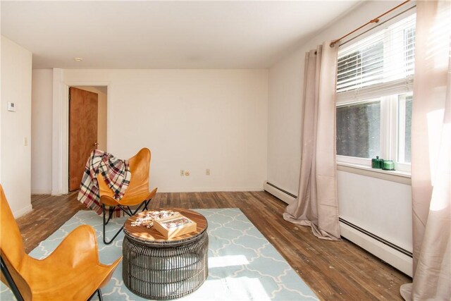 70 Carroll Ave Unit 510, Newport, RI 02840 - sitting room with wood finished floors, a baseboard heating unit, and healthy amount of natural light