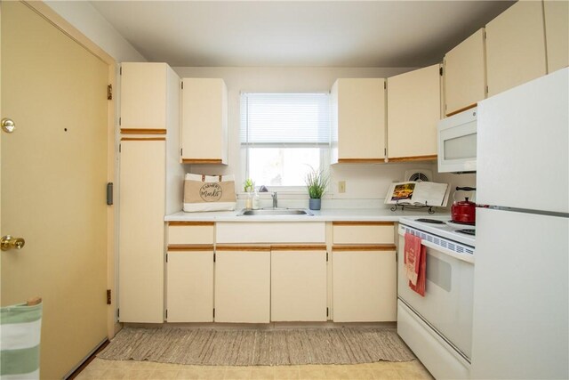 70 Carroll Ave Unit 510, Newport, RI 02840 - kitchen with white appliances, a sink, light countertops, and cream cabinetry
