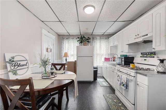 23 Auburn St, Pawtucket, RI 02860 - kitchen featuring white appliances, under cabinet range hood, a drop ceiling, white cabinetry, and a sink