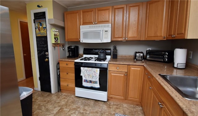 22 Sandy Ln, Westerly, RI 02891 - kitchen with white microwave, range with gas cooktop, crown molding, and a sink