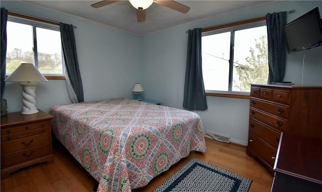 22 Sandy Ln, Westerly, RI 02891 - bedroom featuring light wood-style floors, multiple windows, crown molding, baseboards, and ceiling fan