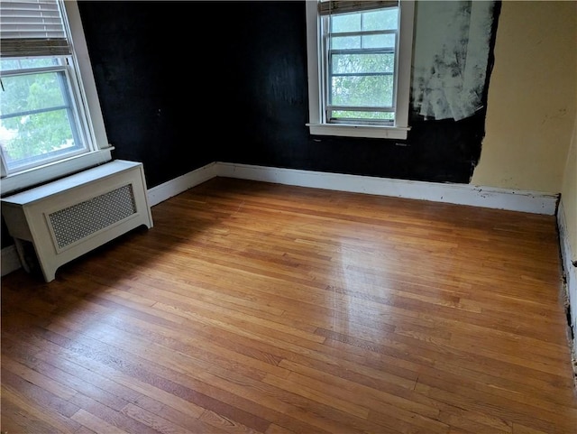 33 Zella St, Providence, RI 02908 - empty room with radiator, wood-type flooring, and baseboards