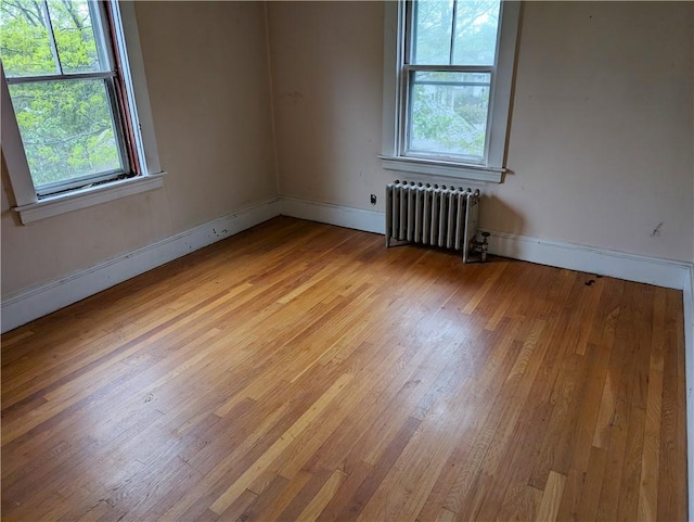 33 Zella St, Providence, RI 02908 - unfurnished room featuring radiator heating unit, light wood-style flooring, and baseboards