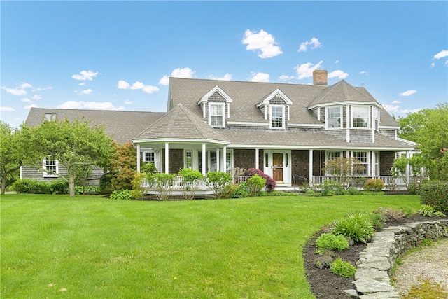 576 W Main Rd, Little Compton, RI 02837 - view of front of house with covered porch, a chimney, a front lawn, and a shingled roof