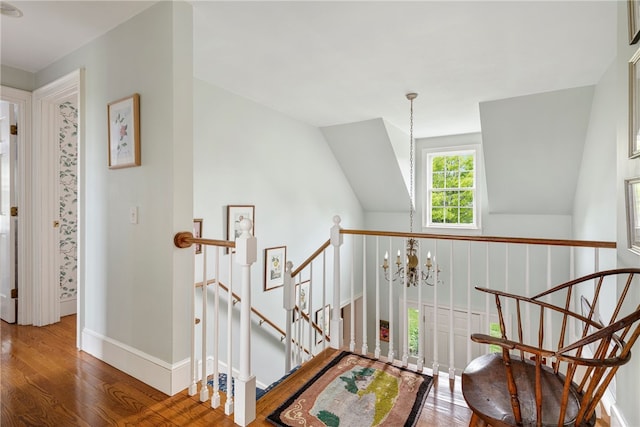 576 W Main Rd, Little Compton, RI 02837 - staircase featuring wood finished floors, a chandelier, and baseboards
