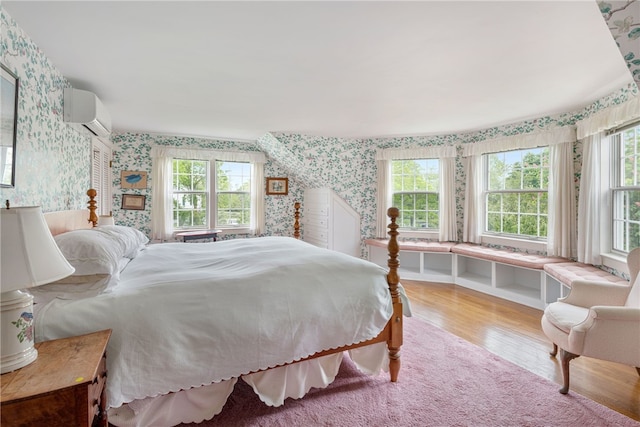 576 W Main Rd, Little Compton, RI 02837 - bedroom featuring wallpapered walls, wood finished floors, and an AC wall unit