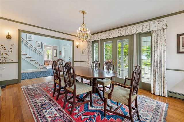 576 W Main Rd, Little Compton, RI 02837 - dining area with french doors, stairs, hardwood / wood-style flooring, crown molding, and a chandelier