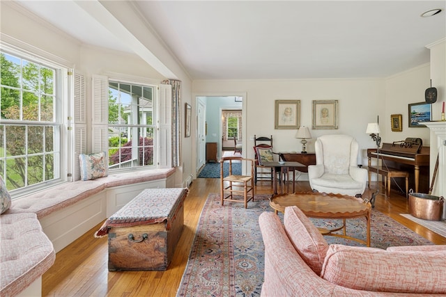 576 W Main Rd, Little Compton, RI 02837 - living room featuring plenty of natural light, wood-type flooring, ornamental molding, and a fireplace with flush hearth
