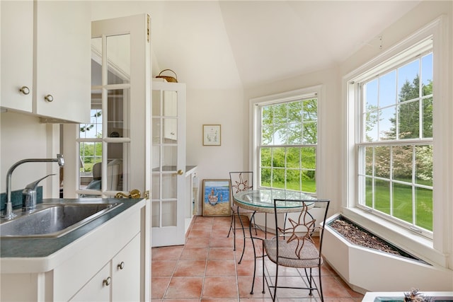 576 W Main Rd, Little Compton, RI 02837 - kitchen with a sink, lofted ceiling, white cabinetry, light tile patterned flooring, and french doors