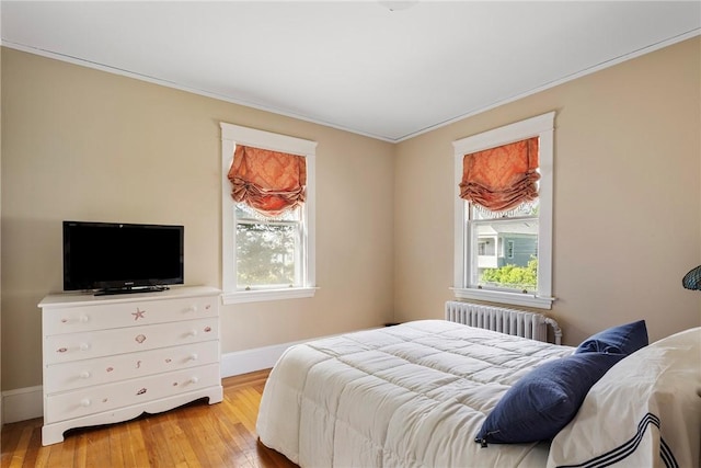27 Cranston Ave, Newport, RI 02840 - bedroom featuring radiator, light wood-style floors, baseboards, and crown molding
