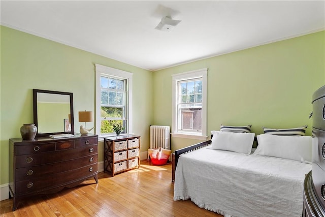 27 Cranston Ave, Newport, RI 02840 - bedroom featuring radiator heating unit, light wood-style floors, baseboards, and ornamental molding