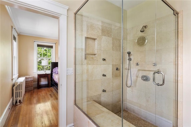 27 Cranston Ave, Newport, RI 02840 - ensuite bathroom featuring radiator heating unit, wood finished floors, a shower stall, and baseboards