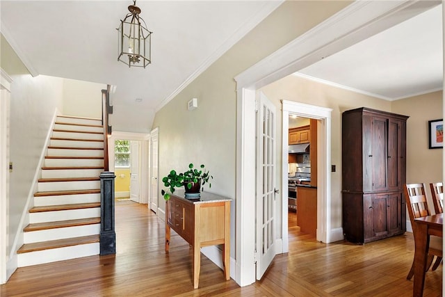 27 Cranston Ave, Newport, RI 02840 - stairway with wood finished floors, crown molding, french doors, and baseboards