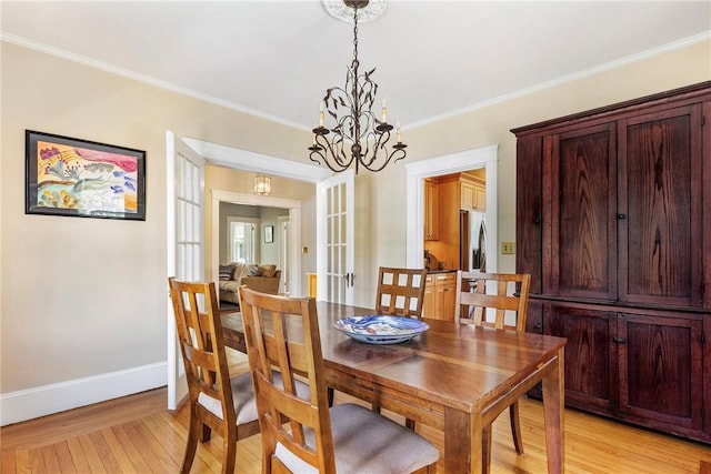 27 Cranston Ave, Newport, RI 02840 - dining space featuring light wood-style floors, a chandelier, crown molding, baseboards, and french doors