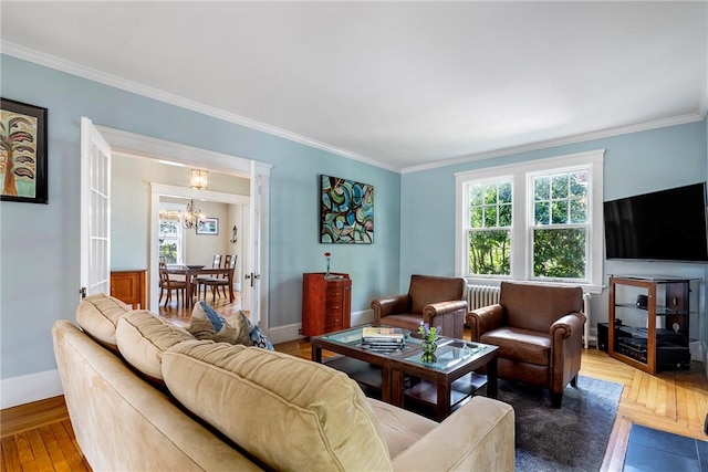 27 Cranston Ave, Newport, RI 02840 - living room featuring healthy amount of natural light, a chandelier, wood finished floors, crown molding, and baseboards
