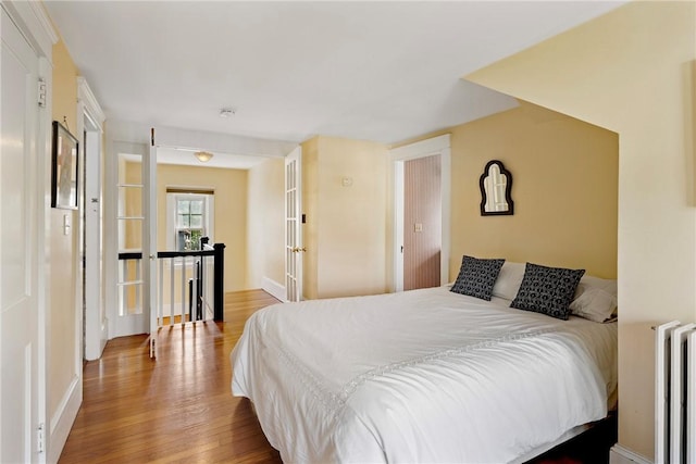 27 Cranston Ave, Newport, RI 02840 - bedroom with wood finished floors, radiator, and baseboards
