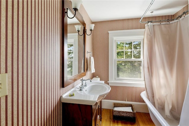 27 Cranston Ave, Newport, RI 02840 - bathroom featuring vanity, wood finished floors, and wallpapered walls