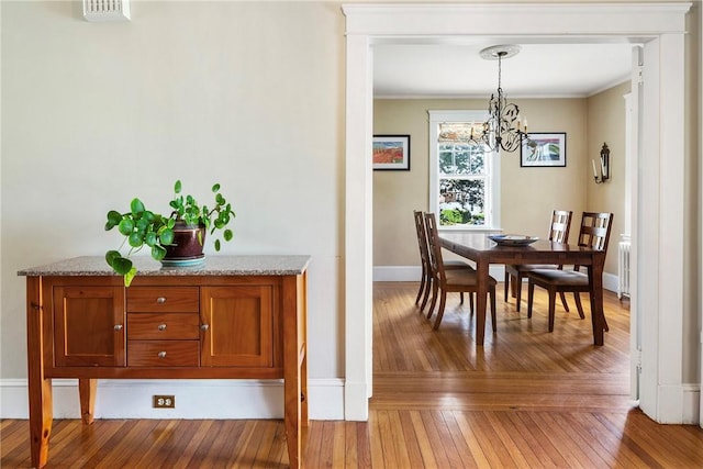27 Cranston Ave, Newport, RI 02840 - dining room featuring a chandelier, hardwood / wood-style floors, crown molding, and baseboards