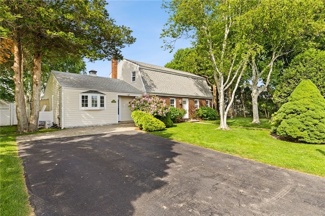 39 Exeter Blvd, Narragansett, RI 02882 - dutch colonial featuring driveway, a chimney, a front lawn, a gambrel roof, and a shingled roof