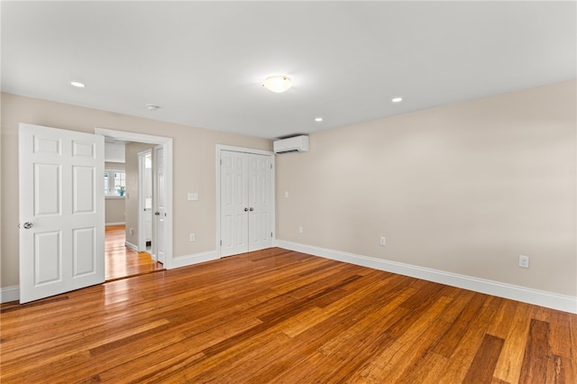 39 Exeter Blvd, Narragansett, RI 02882 - unfurnished bedroom featuring a wall unit AC, light wood-style flooring, baseboards, and recessed lighting