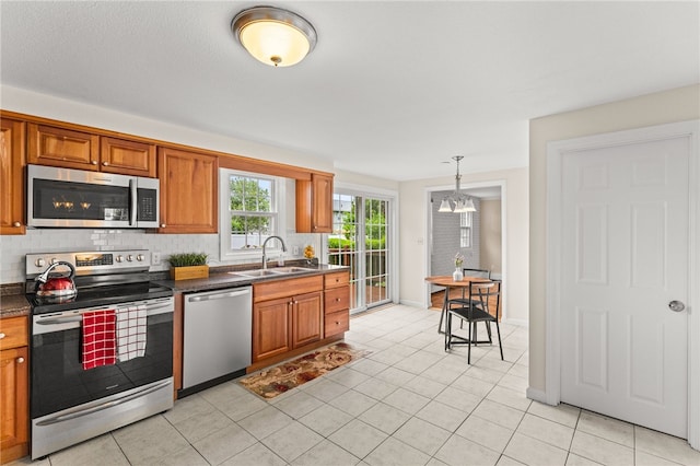39 Exeter Blvd, Narragansett, RI 02882 - kitchen featuring stainless steel appliances, a sink, dark countertops, and brown cabinets