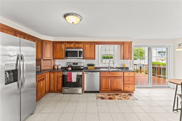 39 Exeter Blvd, Narragansett, RI 02882 - kitchen with appliances with stainless steel finishes, a sink, decorative backsplash, and brown cabinets