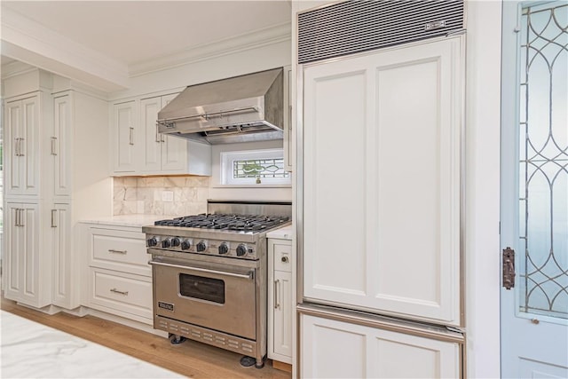 17 E Hills Rd, Westerly, RI 02891 - kitchen featuring wall chimney exhaust hood, designer range, white cabinets, and ornamental molding