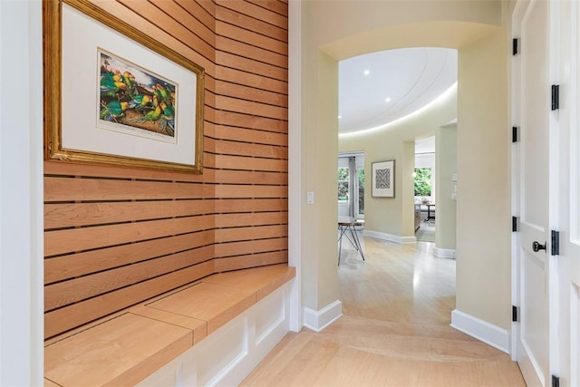 25 Walnut St, Jamestown, RI 02835 - hall with wood walls, light wood-style flooring, and baseboards
