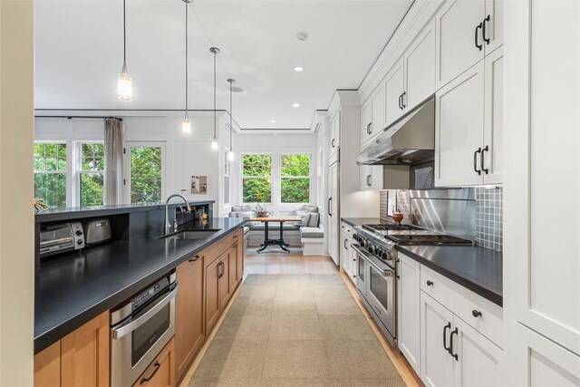 25 Walnut St, Jamestown, RI 02835 - kitchen featuring stainless steel appliances, a sink, dark countertops, under cabinet range hood, and recessed lighting