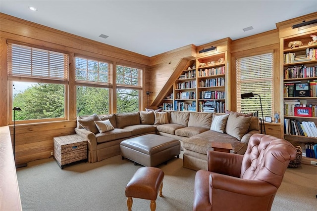 25 Walnut St, Jamestown, RI 02835 - living room with wooden walls, carpet, and healthy amount of natural light