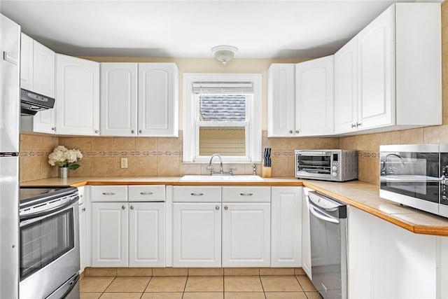 33 Upland Way, Barrington, RI 02806 - kitchen featuring appliances with stainless steel finishes, exhaust hood, and white cabinetry