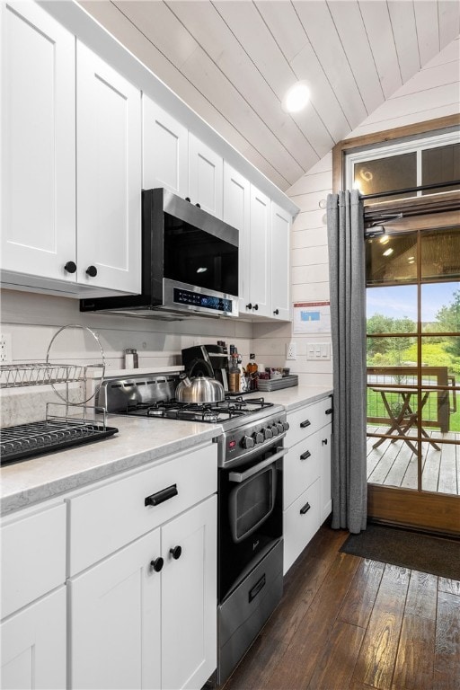 12 Alexander Cir Unit Th2, Richmond, RI 02898 - kitchen featuring gas stove, stainless steel microwave, lofted ceiling, dark wood-type flooring, and white cabinetry