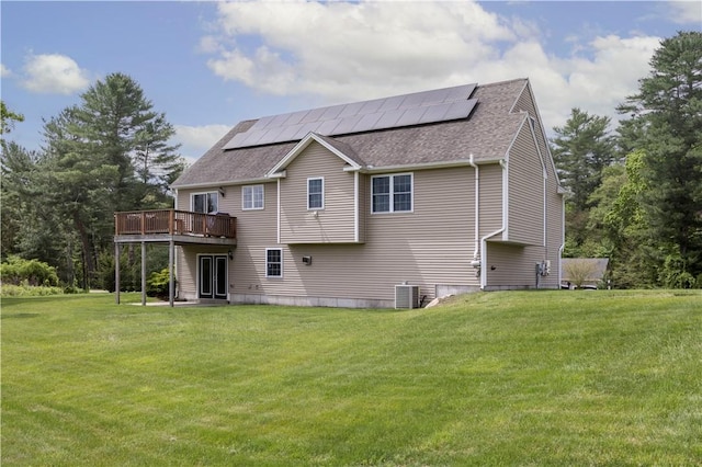 38 Pleasant View Dr, Hopkinton, RI 02832 - back of house with a shingled roof, a yard, roof mounted solar panels, and a wooden deck