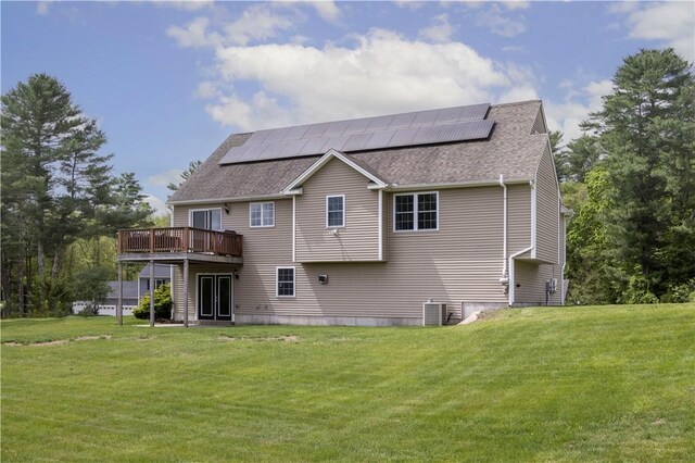 38 Pleasant View Dr, Hopkinton, RI 02832 - back of house with a yard, roof mounted solar panels, roof with shingles, and a deck