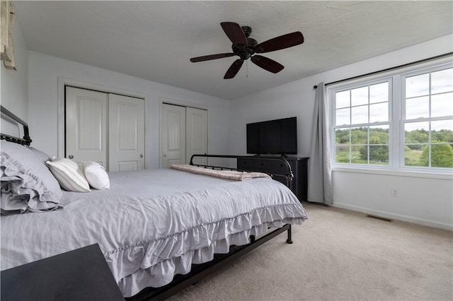 38 Pleasant View Dr, Hopkinton, RI 02832 - bedroom featuring two closets, light carpet, baseboards, and ceiling fan