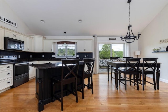 38 Pleasant View Dr, Hopkinton, RI 02832 - kitchen featuring black microwave, stainless steel electric stove, lofted ceiling, tasteful backsplash, and white cabinetry