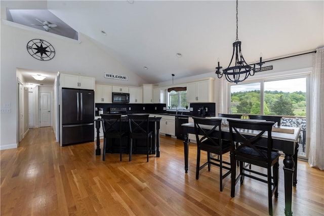 38 Pleasant View Dr, Hopkinton, RI 02832 - dining space featuring a chandelier, high vaulted ceiling, and light wood finished floors