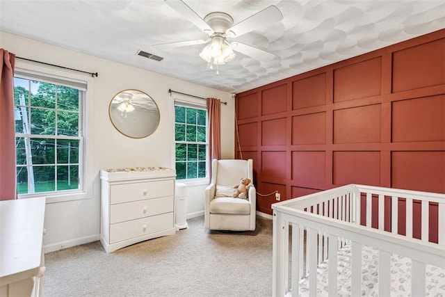 121 Greenbush Rd, Warwick, RI 02818 - bedroom featuring multiple windows, light colored carpet, and a crib
