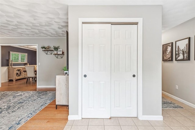 121 Greenbush Rd, Warwick, RI 02818 - corridor with baseboards and light tile patterned flooring