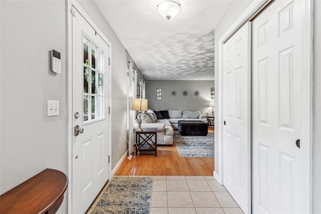 121 Greenbush Rd, Warwick, RI 02818 - entrance foyer with light tile patterned floors and baseboards