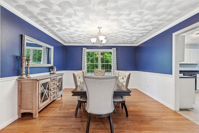 121 Greenbush Rd, Warwick, RI 02818 - dining space with a chandelier, crown molding, a wainscoted wall, and light wood-type flooring