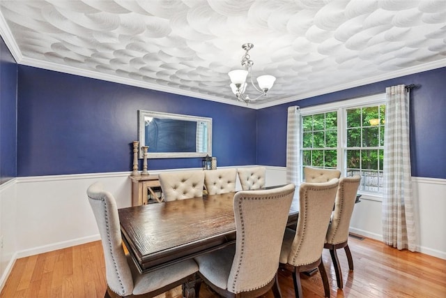 121 Greenbush Rd, Warwick, RI 02818 - dining area with a chandelier, wainscoting, ornamental molding, and hardwood / wood-style floors
