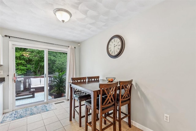 121 Greenbush Rd, Warwick, RI 02818 - dining area with light tile patterned flooring and baseboards