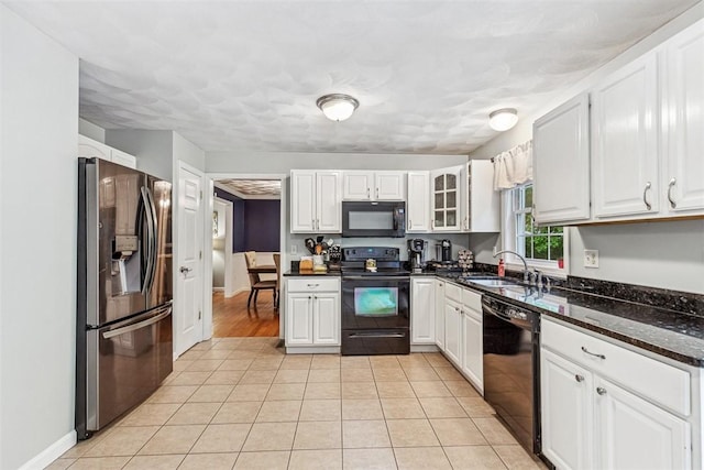 121 Greenbush Rd, Warwick, RI 02818 - kitchen with black appliances, a sink, white cabinets, light tile patterned flooring, and dark stone countertops