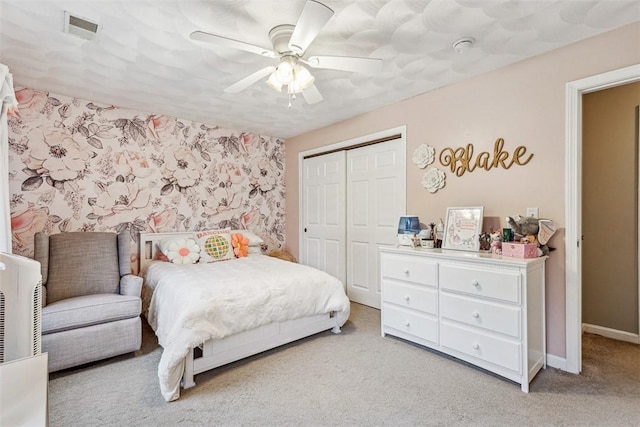 121 Greenbush Rd, Warwick, RI 02818 - bedroom with a closet, light colored carpet, a ceiling fan, baseboards, and wallpapered walls
