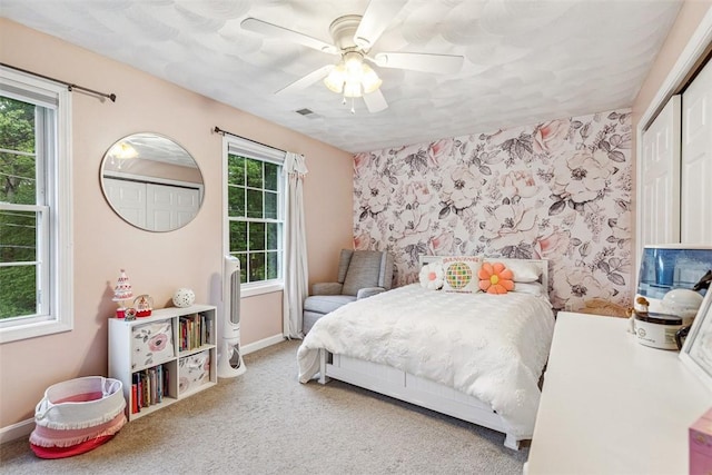 121 Greenbush Rd, Warwick, RI 02818 - carpeted bedroom with multiple windows, ceiling fan, baseboards, and wallpapered walls