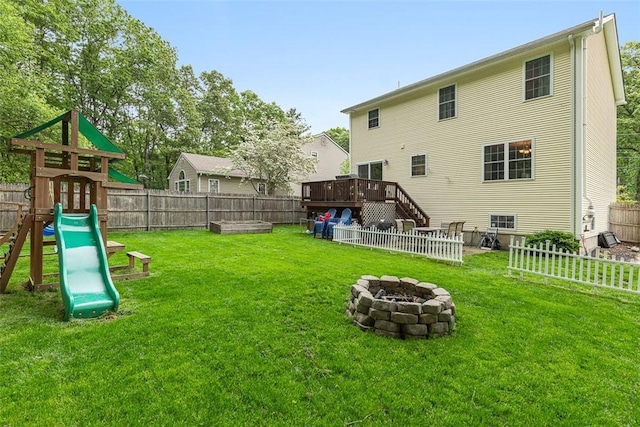 121 Greenbush Rd, Warwick, RI 02818 - rear view of property featuring an outdoor fire pit, a playground, and a wooden deck