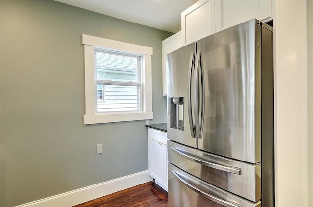 101 Knollwood Ave, Cranston, RI 02910 - kitchen featuring stainless steel refrigerator with ice dispenser, dark countertops, white cabinets, baseboards, and dark wood finished floors