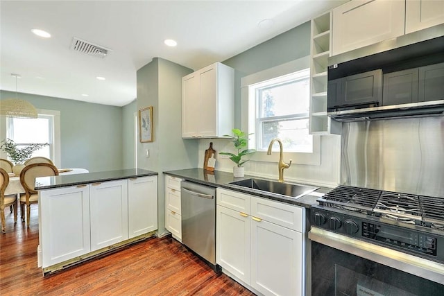 101 Knollwood Ave, Cranston, RI 02910 - kitchen featuring stainless steel appliances, a sink, a peninsula, open shelves, and healthy amount of natural light